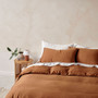 Linen House Surf Wash Rust quilt cover set styled on a bed