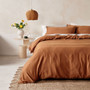 Linen House Surf Wash Rust quilt cover set styled on a bed