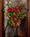 Pine and berry silk swag 16" wide teardrop of pine winter greens and cones with shiny red berries on a decorative metal base