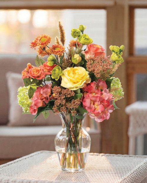 Pink and orange silk flower arrangement with roses, hydrangeas and daisies in vase by Petals
