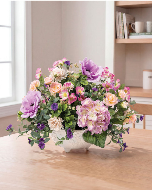 Large garden-inspired silk floral arrangement with hydrangeas, roses, cosmos, petunias, anemones, and mums in a white ceramic footed bowl with cascading string of pearls design, 14 inches high by 19 inches wide.