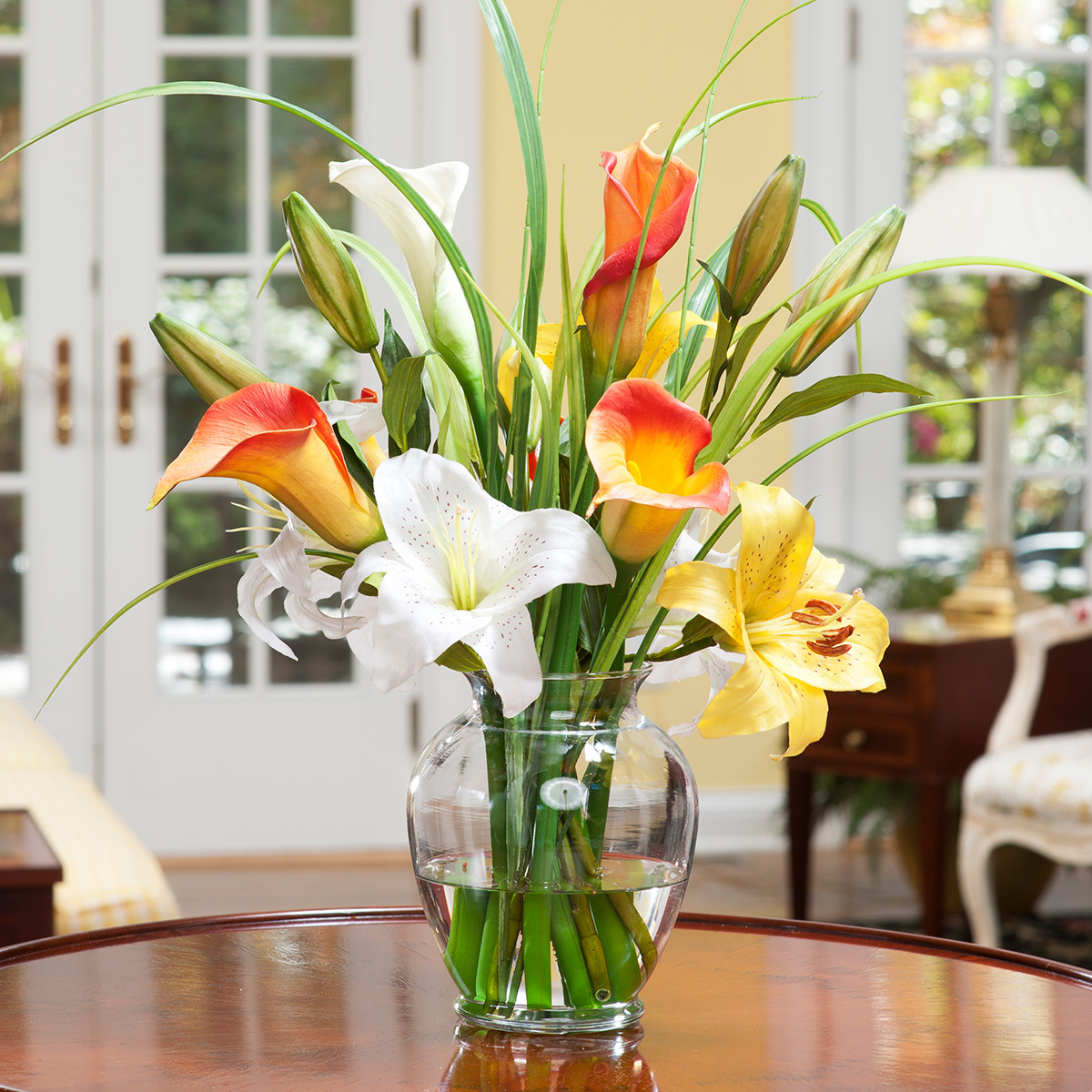 Calla lily and day lily silk flower arrangement in a ginger vase