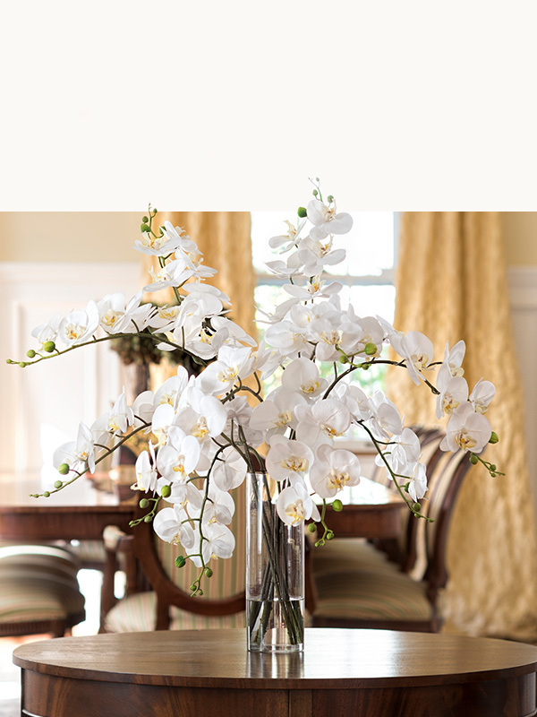 Realistic faux orchid floral arrangement by Petals with delicate exotic orchid stems designed for year-round beauty and maintenance-free decorating.