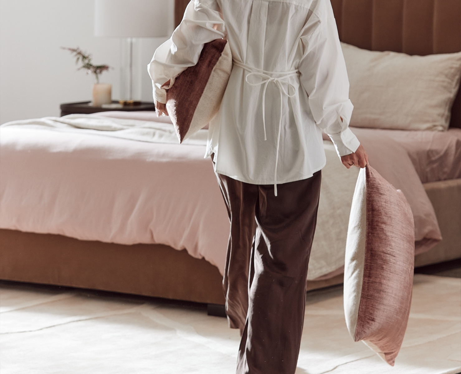 A woman holding cushions