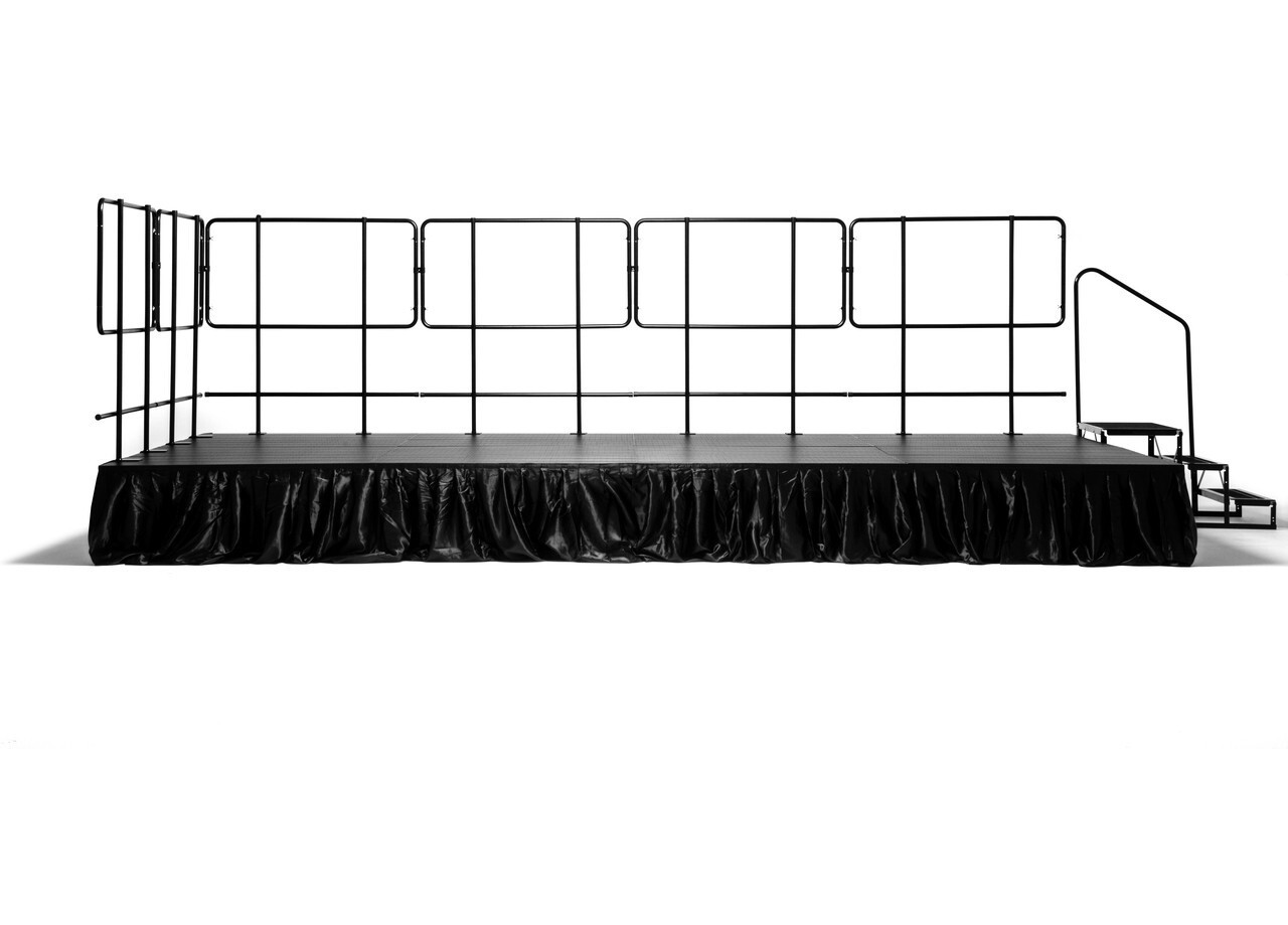 An 8 ft x 16 ft MyStage portable stage with railings, black skirting and stairs