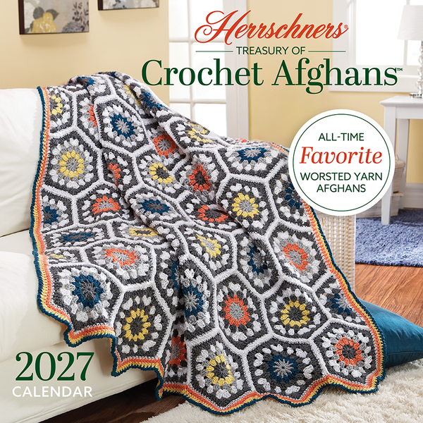 Herrschners Treasury of Crochet Afghans 2027 calendar cover showing a colorful hexagon crochet afghan made with worsted-weight yarn draped over a sofa.