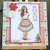 The girl in a red and cream outfit layered on patterned holiday papers with a wooden star, reading 'Believe in the magic of the season.'