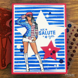 Blue striped card with white and red die cut stars behind a hand colored saluting girl, stamped 'we SALUTE you'.