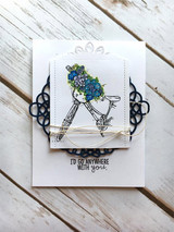 Clean white card with the flower-basket bicycle colored in blues over a navy die-cut flourish, stamped 'I'D GO ANYWHERE WITH you.'