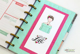Planner page decorated with Angie Blom's itty bitty Planner Gals in off-shoulder tops and floral crowns, sentiment 'Living one amazing happy life'.