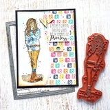 Card layered on camera-print paper with Cierra Girl in a blue top and mustard jeans, shown beside the red rubber stamp itself.