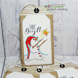 Tag with a red-hatted snowman holding a star and 'Shine Bright.'