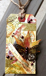 Tag with a leaf stamped in golds and a butterfly accent