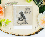 Sample card with the mother and baby stamped in sepia on kraft, layered on lace trim and white cardstock, styled on a wood slice with roses and sequins.