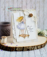 White card with the girl colored with blonde hair and a lavender dress on a wooden swing beside the adventure quote, with a doily, twine and a flower accent.