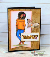 Card with Nia colored in an orange top and blue jeans beside a stamped butterfly on crumpled kraft paper, over 'You are amazing remember that.'