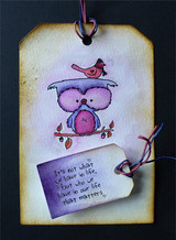 Inked tag with the owl colored in purple and pink and a red bird above, with the 'It's not what we have in life' sentiment on a small purple tag.