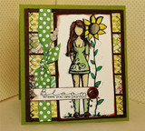 Olive green card with brown and patterned paper panels, green ribbon and a button, the girl colored beside her sunflower and a strip reading Bloom where you are planted.