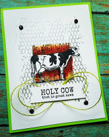 The cow on a chicken-wire textured card with a green frame and knotted twine — 'HOLY COW that is great news.'