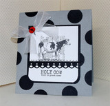 A black-and-white Holstein cow on a bold polka-dot grey card tied with sheer ribbon — 'HOLY COW that is great news.'