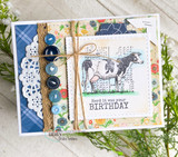 The cow stamp on a layered plaid and floral card with a lace doily and buttons — 'Herd it was your birthday.'