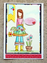 Watercolor card with Andie in a pink top, blue floral apron and yellow boots beside a pink potted flower, with a thank you bubble and a yellow banner.