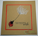 Kraft card with the dandelion wish and ladybug over a red panel, 'every dream begins with a simple wish.'