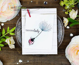 White card with the dandelion and ladybug and 'sending beautiful wishes' among fresh roses.
