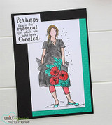 Black and teal card with Peyton in a gray tunic and coral pants, red poppies in her pocket, and a script sentiment label