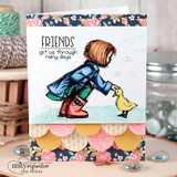 Card with navy floral paper and a scalloped border: the girl in a blue coat and red boots greets the duckling under the rainy-days sentiment.