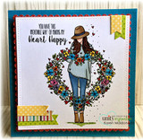 Card with the wreath girl framed in bright florals on a teal border.