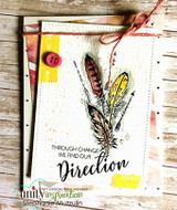 Rustic card with the feathers in yellow and grey on a woodgrain panel with a red button and twine, and the through change we find our direction sentiment.