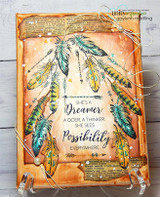 Distressed orange card with the feathers in teal and gold arranged in an arch around a dreamer sentiment from another set.