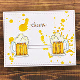 Handmade card with two frothy beer mugs mirrored and clinking together, with "Cheers."