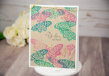 Card with a pastel butterfly print background and gold 'mom' die-cut.