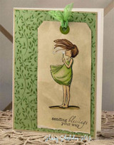 The dandelion girl in a green dress on a green tag-style card with 'sending blessings your way.'