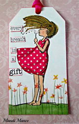 The dandelion girl in a red polka-dot dress on a tag with 'every breath is a gift.'