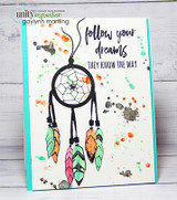 White card with an aqua edge and orange, green and gray ink splatters, a black dreamcatcher with watercolored pink, green and orange feathers, and 'follow your dreams they know the way'.