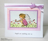 A soft pink and lavender card with the winged girl colored in pink among the grasses, tied with a purple ribbon.