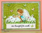 A green grid card with the winged girl colored in pink and peach among wildflowers, butterflies scattered above, and a stitched strip reading 'too beautiful for earth.'