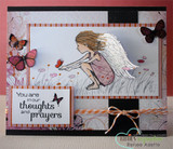 A black and red card with the winged girl colored in pink among poppies, layered with butterflies and a panel of sentiment text.