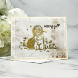 Card with a gold-embossed shaggy dog holding a dandelion on a vellum panel and 'missing you.'