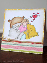 Card with the girl in pink and a golden dog in bed with red hearts floating above, on a white panel with a twine button and pink and green borders