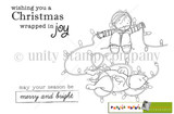 Stamp sheet: a boy sitting with a string of Christmas lights stretched between his hands and a dog lying tangled in the strand, with 'wishing you a Christmas wrapped in joy' and 'may your season be merry and bright'.