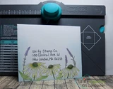Envelope stamped with coneflowers along the bottom and a hand-written return address.
