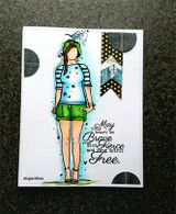 Card with Wren Girl in a pale blue star tee and green shorts with a blue bird on her green cap, denim and polka dot banners, and the 'May your heart be Brave' sentiment on a charcoal background