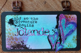 Mixed-media journal card in teal and purple grunge with 'and so the adventure begins' and a 'Jolande' word.