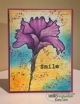 Vivid card with the flower in purple over an orange, pink and teal ink-blended panel with splatters and the word Smile.