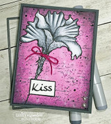 Grey and pink card with the flower stamped in white on a bright pink splattered panel, a red twine bow, and the word Kiss.