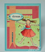 Sample card: the girl in a red dress on pink, orange and teal patterned papers with a 'dream.' oval